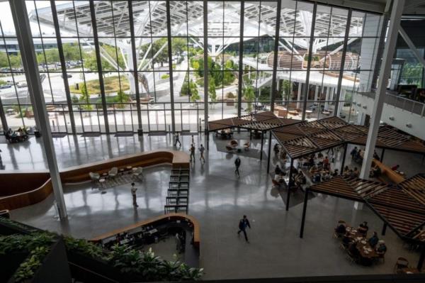 Employees inside the Voyager building at Nvidia headquarters in Santa Clara, California, US, on Monday, June 5, 2023. Nvidia Corp., suddenly at the core of the world's most important technology, owns 80% of the market for a particular kind of chip called a data-center accelerator, and the current wait time for one of its AI processors is eight months. Photographer: Marlena Sloss/Bloomberg via Getty Images